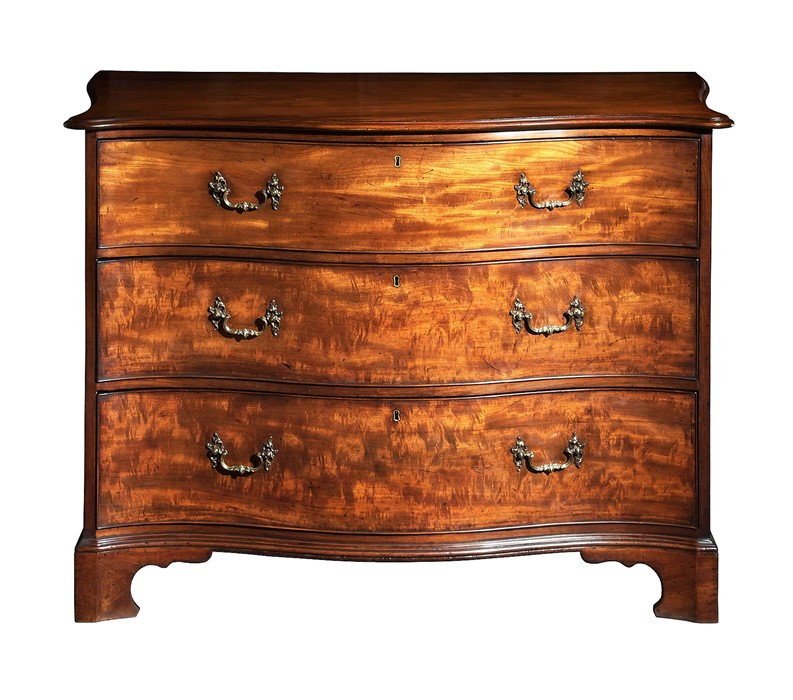 A George III mahogany serpentine chest attributed to Thomas Chippendale