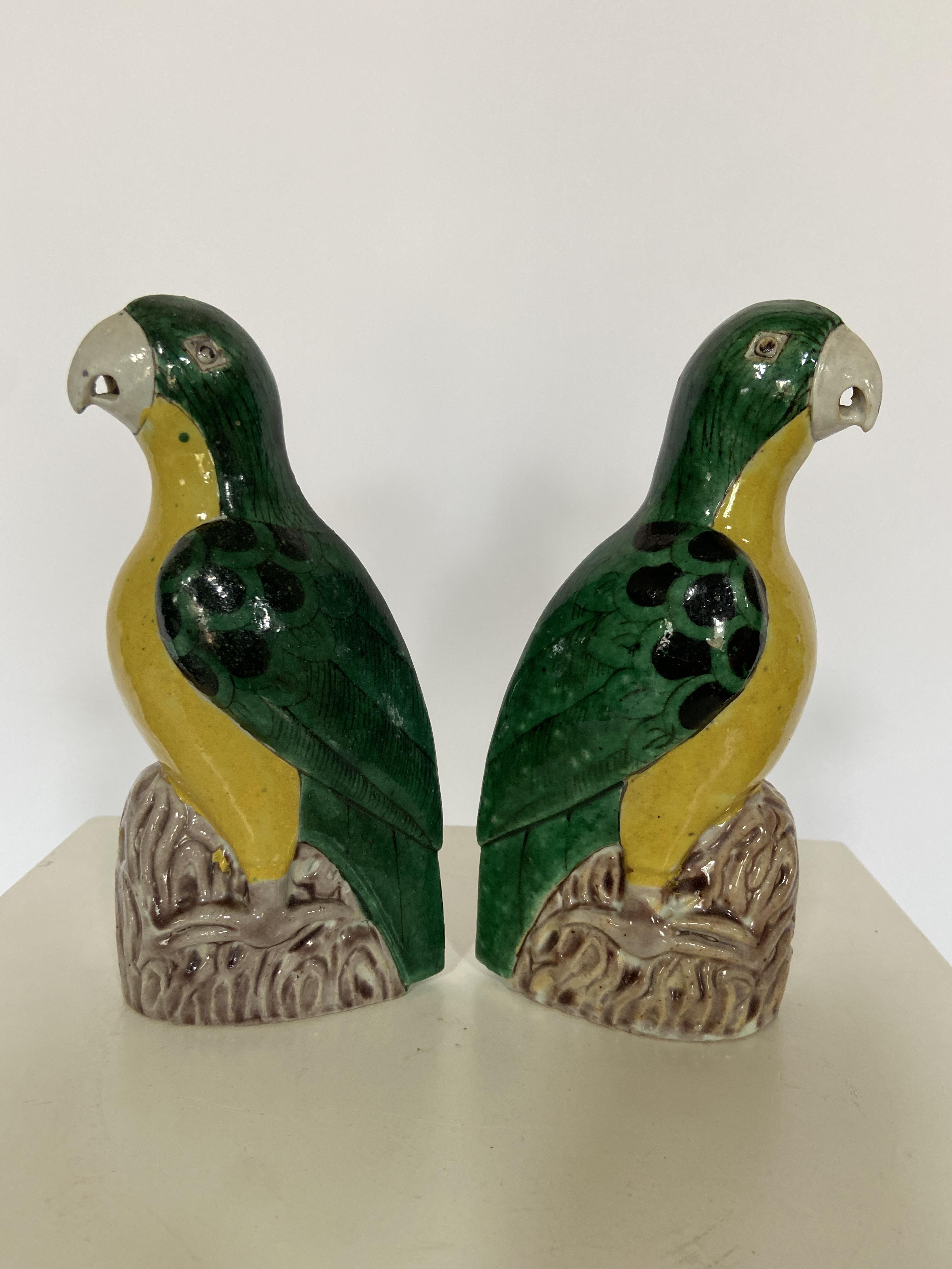 A pair of Chinese- Export green and yellow glazed pottery parrots