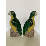 A pair of Chinese- Export green and yellow glazed pottery parrots