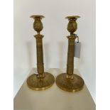 A pair of French Empire gilt bronze candlesticks / table lamps