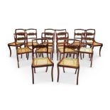 A set of twelve Regency mahogany carved dining chairs