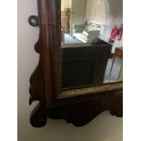 A George III mahogany and parcel gilt fret carved mirror