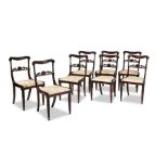A set of eight Regency rosewood carved dining chairs