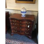 A small George III mahogany serpentine chest