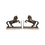 A pair of 1930's Art Deco patinated bronze bookends in the form of horses by H.S.M.Chen