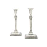 A pair of George III silver candlesticks of neo-classical form, maker’s mark of John Sidaway, London
