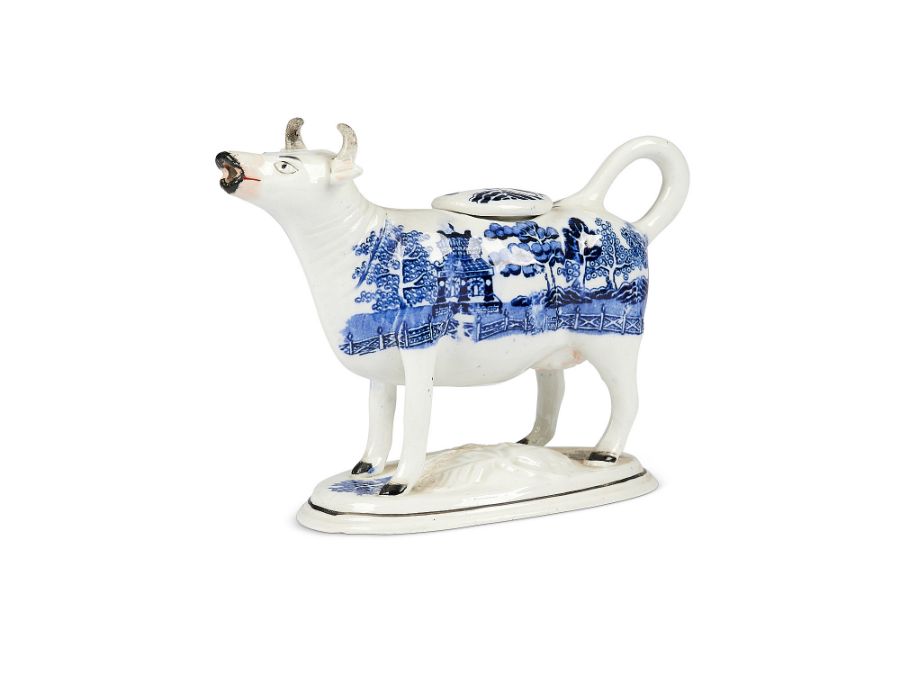 A 19th century Staffordshire blue and white willow pattern cow creamer