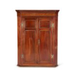 A George III mahogany corner cupboard