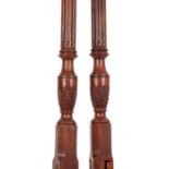 A set of George III mahogany carved bed posts