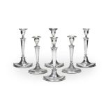 A set of four late 18th century Sheffield plate candlesticks and a further pair