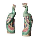 A pair of early 20th century Chinese green and polychrome glazed porcelain figures of phoenixes