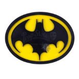 Lot # 32: BATMAN - Batman's (Michael Keaton) Screen-Matched Bullet-Hit Chest Emblem