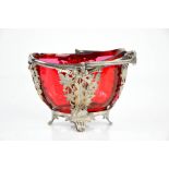 A silver plated and cranberry glass basket, 10cm high.