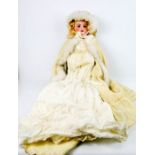 A German Armand Marseille bisque head doll, numbered 390 to the back of the head, wearing a winter