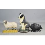 Three cast iron door stops, in the form of a collie dog, sheep and hedgehog.