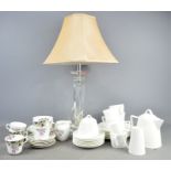 A John Lewis glass table lamp together with a quantity of cups and saucers