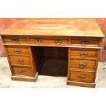 An Edwardian oak pedestal desk.