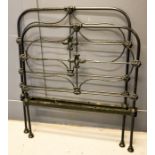 A Victorian black painted cast iron single bed.