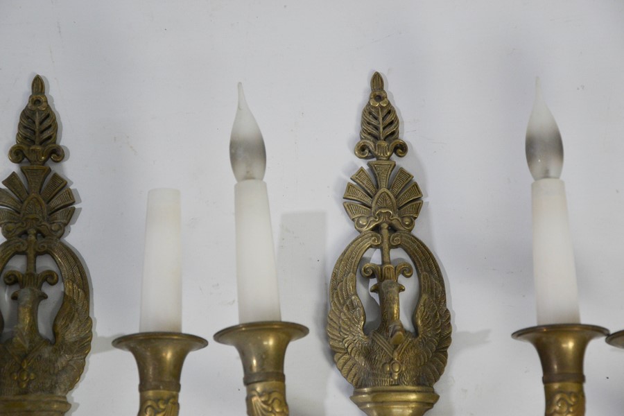 A set of four Empire style brass wall lights, each with twin branches, and the backs cast with - Bild 2 aus 3