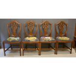A set of four 19th century mahogany dining chairs with Prince of Wales feather carved backs, and