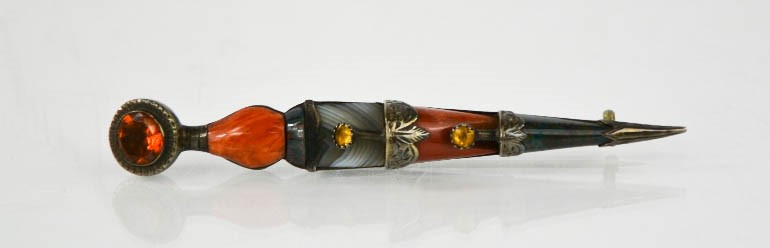 A Scottish dirk pin, set with agate, citrine, sardonyx and green bloodstone, in silver.