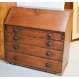 A Victorian oak bureau, with fall front enclosing a fitted interior, with four long graduated