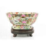 An early 20th century Chinese enamelled bowl on stand, depicting panels of flowers, birds and