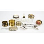 Three silver spoons, a silver napkin ring, a small circular silver photograph frame, a silver and