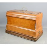 A sewing machine in a marquetry mahogany case.