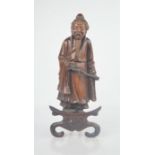 A Chinese wooden carved figure on stand. 33cm