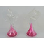 A pair of cranberry glass and vaseline glass bud vases. 22.5cm high