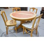 A modern pine kitchen table and chairs, extending, inset with terracotta tiles, with four matching