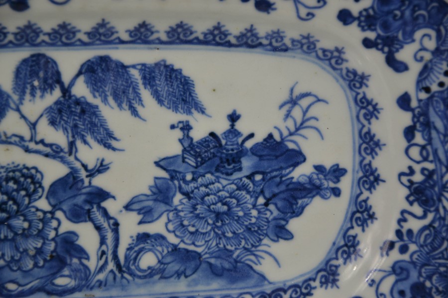 A 19th century Chinese blue and white plate, the centre depicting a table laden with auspicious - Image 2 of 3