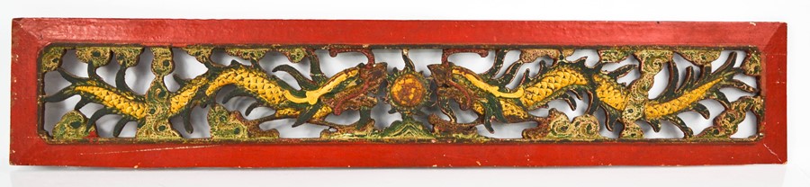 A late 19th century Chinese panel, pierced and carved with dragons and flaming pearl, painted with