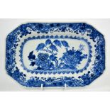 A 19th century Chinese blue and white plate, the centre depicting a table laden with auspicious