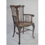 A 19th century oak kitchen armchair.