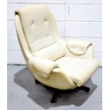 A Parker Knoll style faux leather cream swivel armchair.