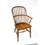 A 19th century Windsor chair, with hoop back, pierced with spindles, the elm seat raised above a H-