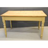 An antique pine kitchen table with painted legs. 74cm by 126cm by 75cm