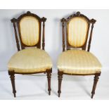 A pair of Edwardian mahogany bedroom chairs, with decorative carved and upholstered back and seats.