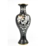 A Chinese black enamel and mother of pearl inlaid vase, depicting peacocks and flowers, 60cm high.