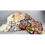 A patchwork quilt, tea cosy, vintage children's nightie, and Victorian nightgown.