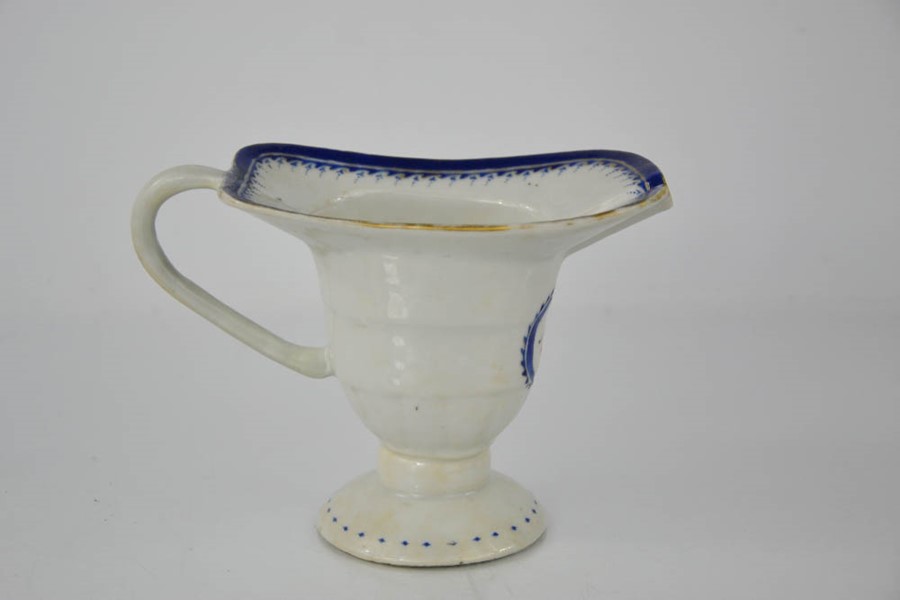 A 19th century sauce boat, bearing armorial crest with two birds, footed base, 11cm high. - Image 3 of 5