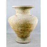 An early Chinese earthenware vase, embossed with decoration, A/F, 46cm high.