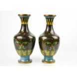A pair of black ground cloisonne baluster vases, with turquoise base and polychrome stylised foliate