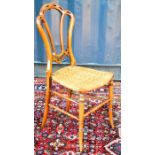 A Victorian bedroom chair with a rush seat, shaped back and turned leg and stretchers, 85cm tall.