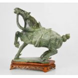 An early 20th century Chinese soapstone horse on wooden stand, 37cm high.