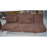 A brown suede sofa bed on a chrome base with a ratcheted movement