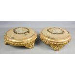 A pair of 19th century giltwood footstools with needlework tops, 30cm diameter.