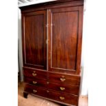 A 19th century Georgian mahogany linen press, with two large cupboard doors, enclosing sliding